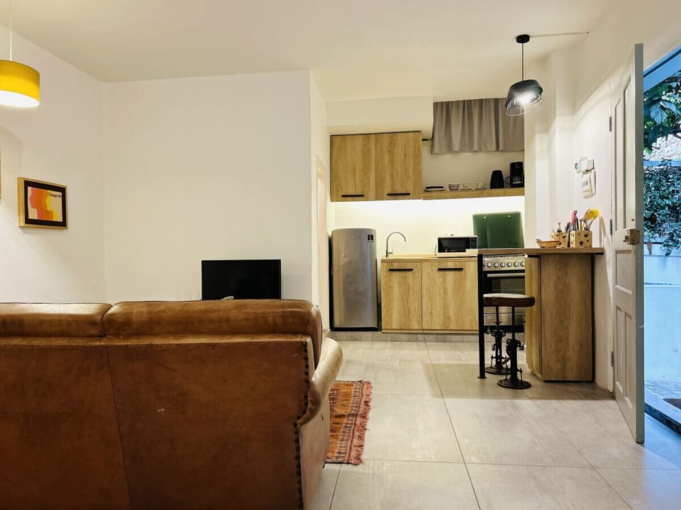 An open studio layout with kitchen, lounge, and ease