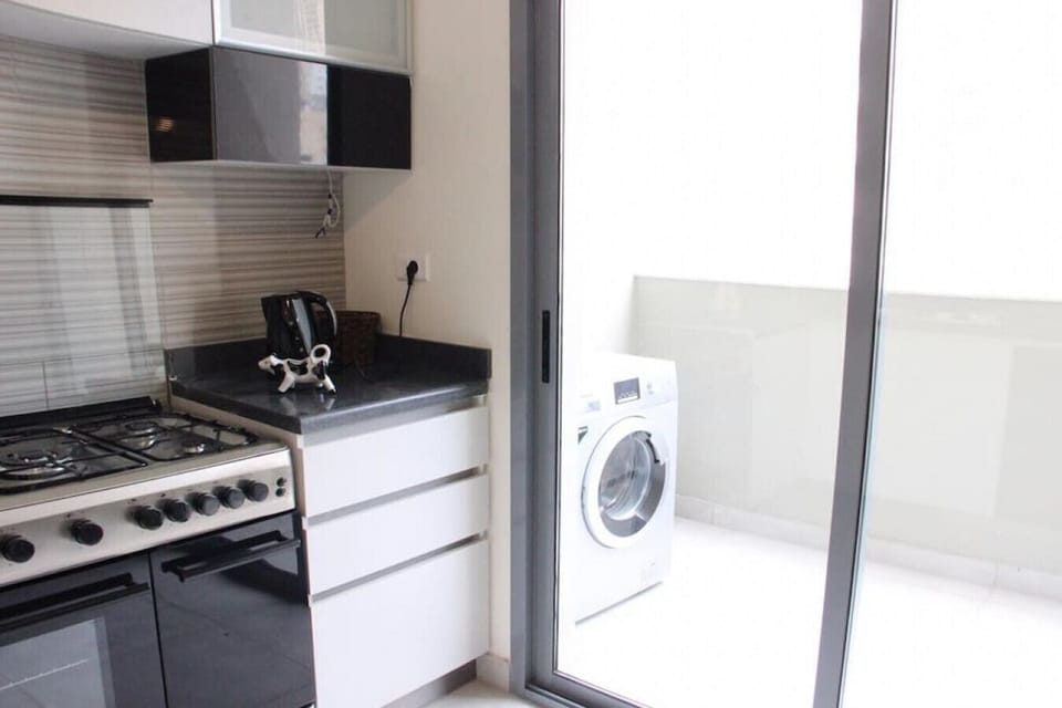 Functional cooking area paired with an adjacent outdoor laundry space.