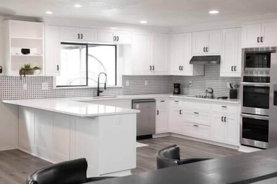 Pristine kitchen with plenty of built-in cabinets and quartz countertops