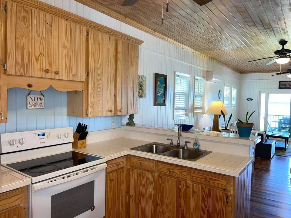 Open kitchen, dining, and living areas - all with perfect turquoise views.