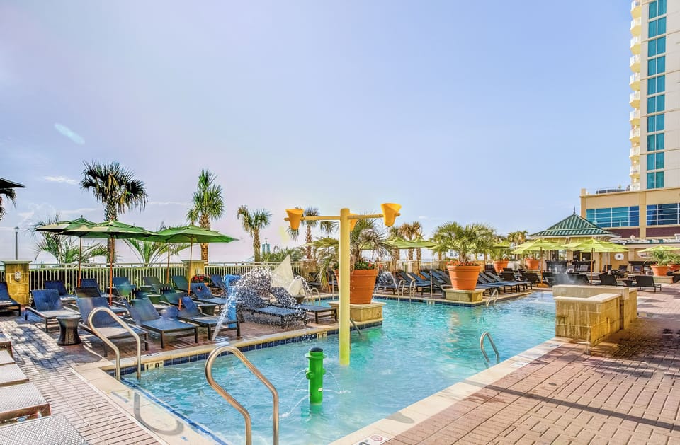 Splash and unwind in the sparkling pool with palm views.