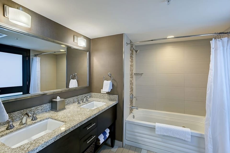 Refresh comfortably with a double vanity and bright lighting.
