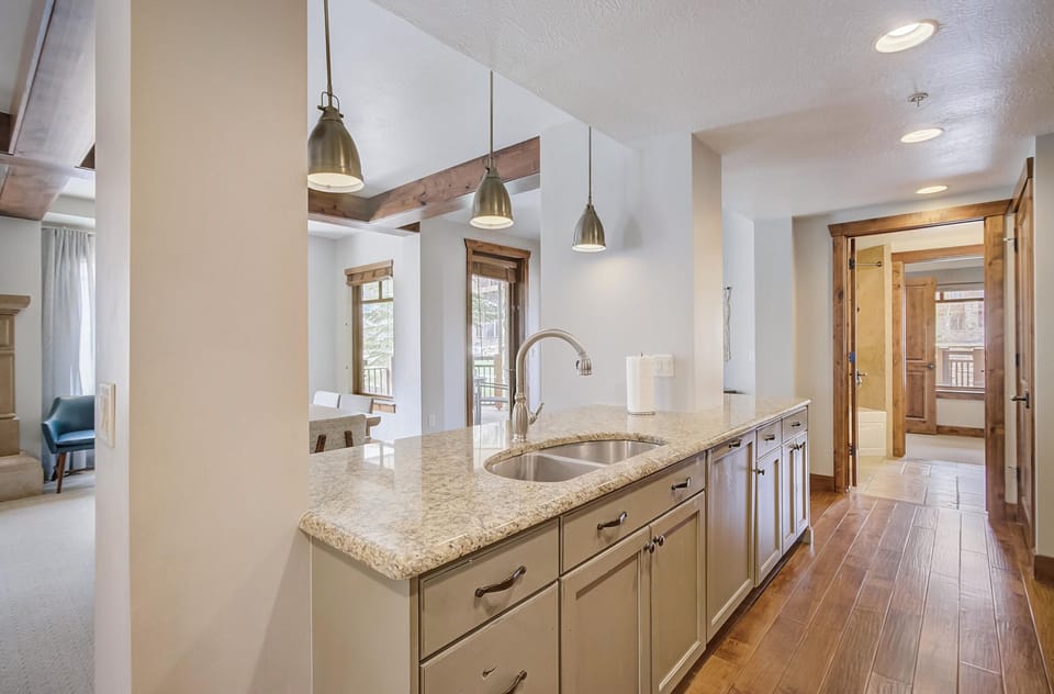 The kitchen island is wonderful working space and dining space for 3.