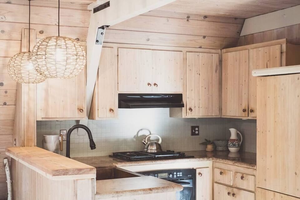 Kitchen includes a 4 burner gas stove, combo Microwave/Convection oven + vent, copper sink, and breakfast bar.
