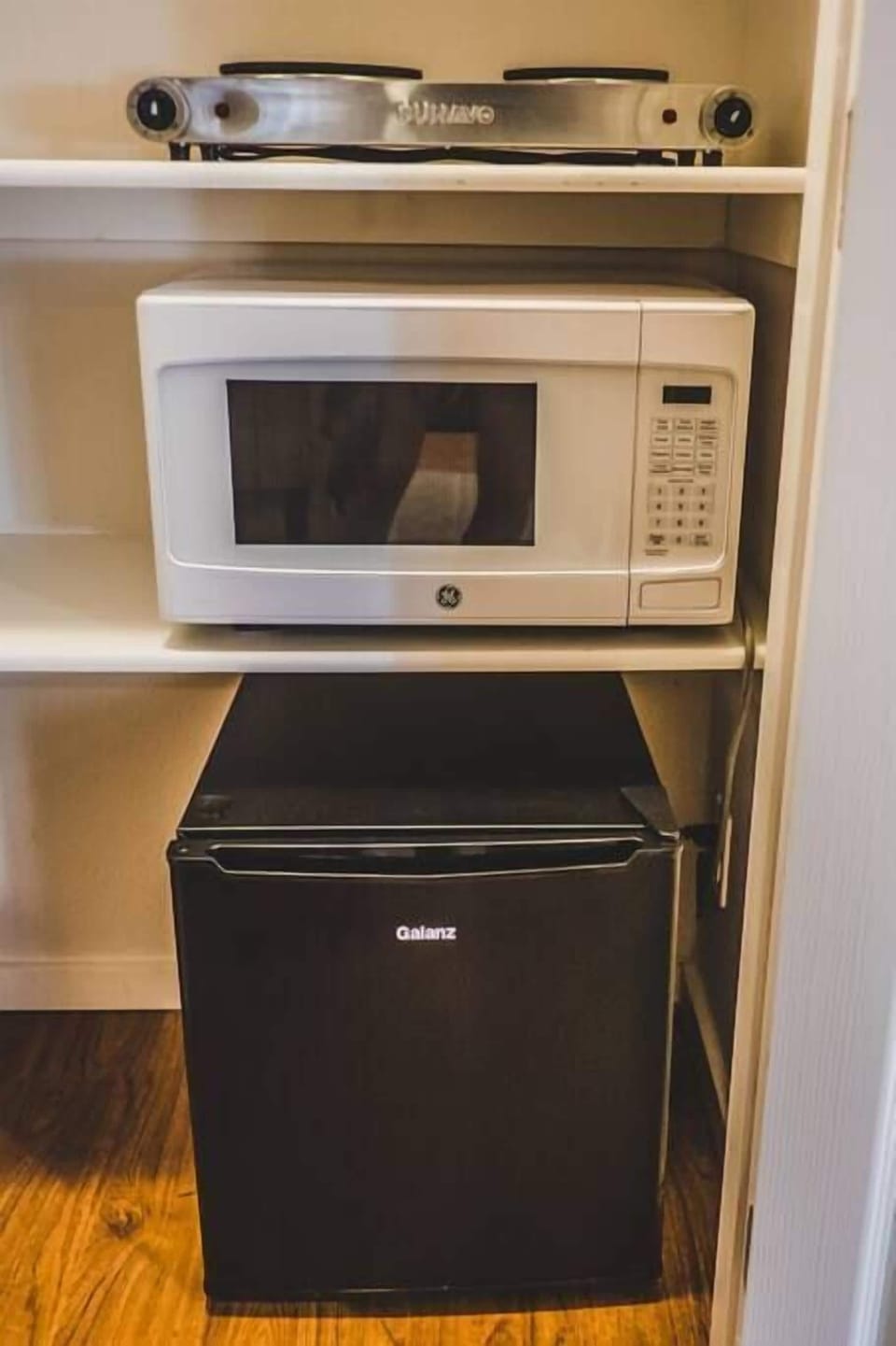 A double burner hot plate, microwave, and mini-fridge round out the kitchenette amenities. Everything you need, and nothing you don't for a relaxing weekend getaway. 