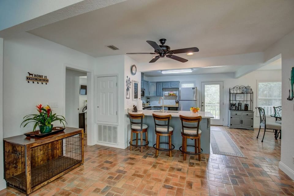 Open area full kitchen with bar stool seating.  Dog crate provided.
