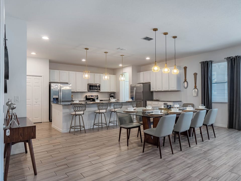 - Spacious kitchen and dining with seating for large groups  
- Modern pendant lighting above island with granite counters  
- Fully equipped with stainless steel appliances for cooking