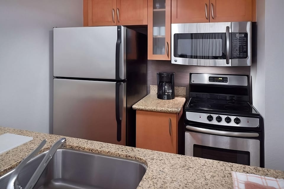 Brew morning coffee and heat snacks with kitchen essentials nearby.