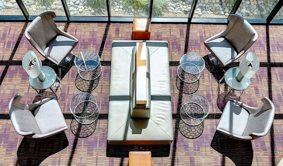 Sip coffee in sunlit lounge seating with a calm vibe.