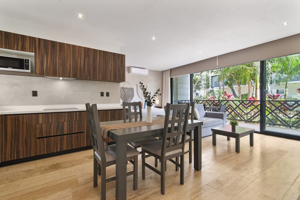 Stylish open-plan living with modern kitchen and lush green views. ✨