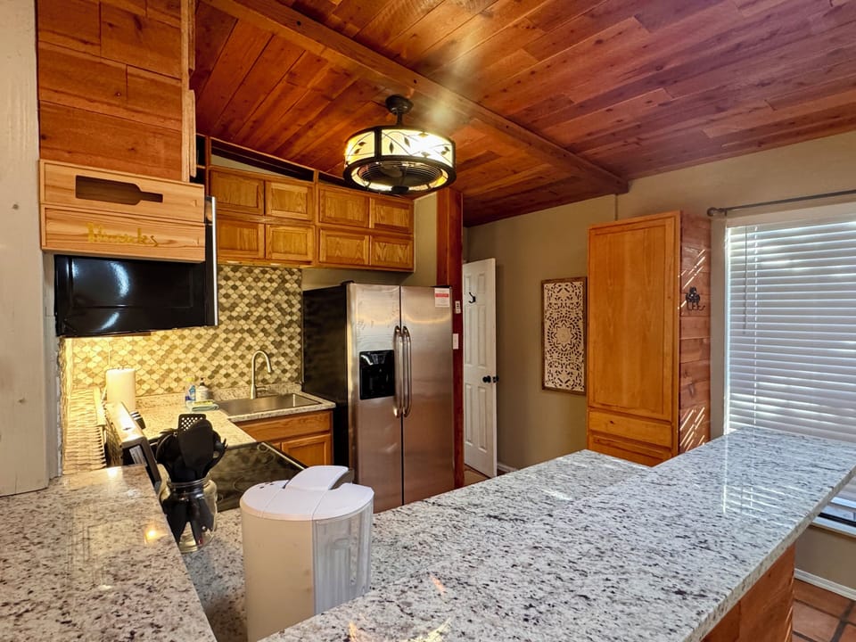 Full kitchen includes microwave, Keurig, electric stove, and refrigerator