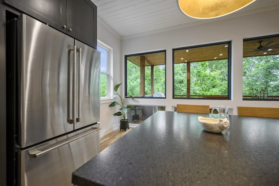 Kitchen: Bright and airy space with modern appliances and lush views for your culinary adventures!