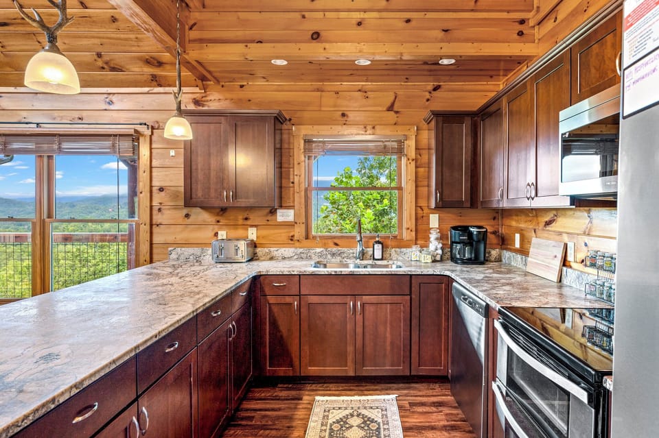 Sip your coffee with Mt. Leconte views from the kitchen windows! Double oven, Keurig, spices, bartop seating and open concept is perfect for group entertaining.