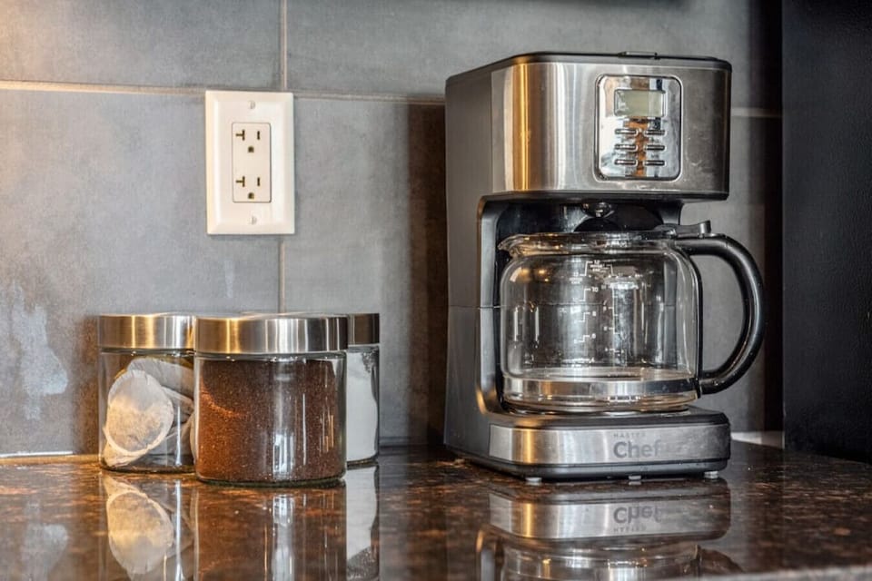 Full kitchen with a drip coffee maker, ground coffee, tea, sugar, and basic condiments (ketchup, mustard & relish.)