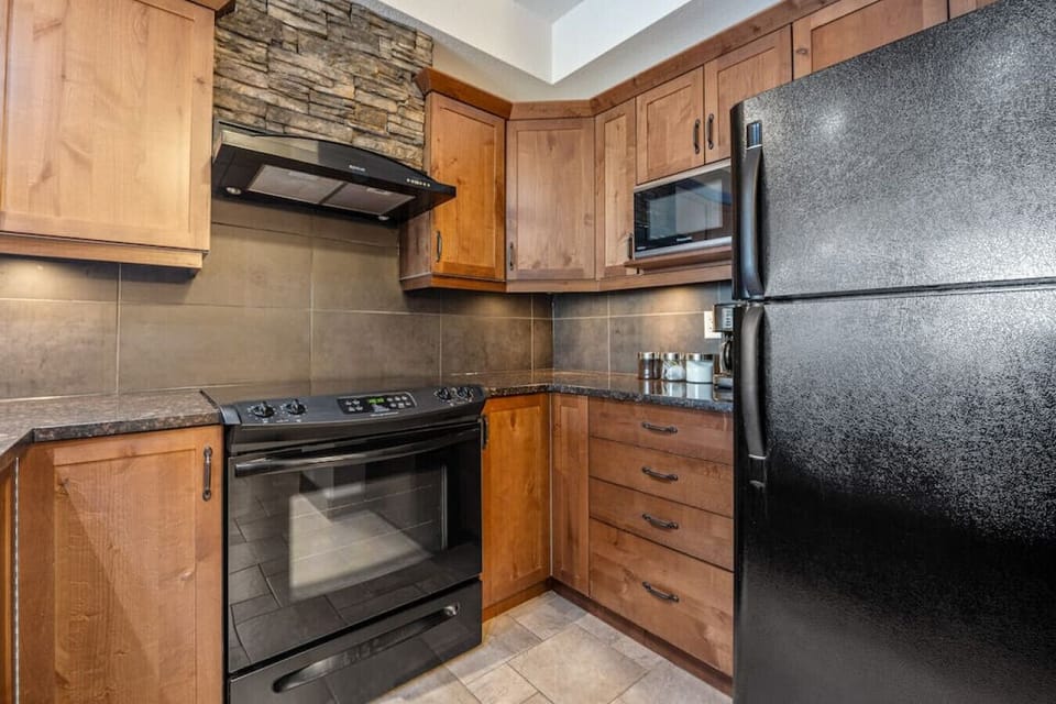 Full kitchen with a drip coffee maker, ground coffee, tea, sugar, and basic condiments (ketchup, mustard & relish.)