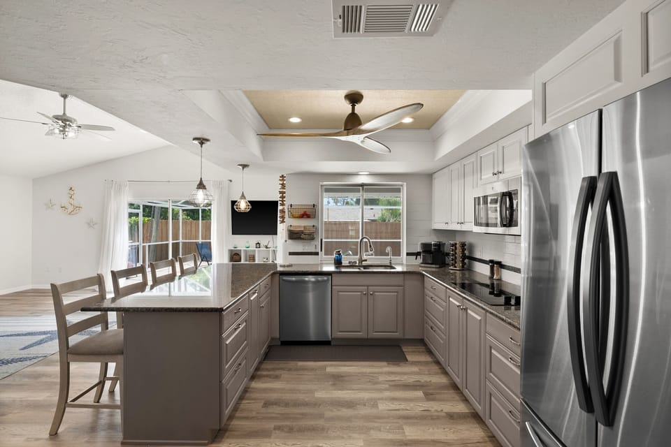 galley kitchen fully stocked with pool views. straight 
