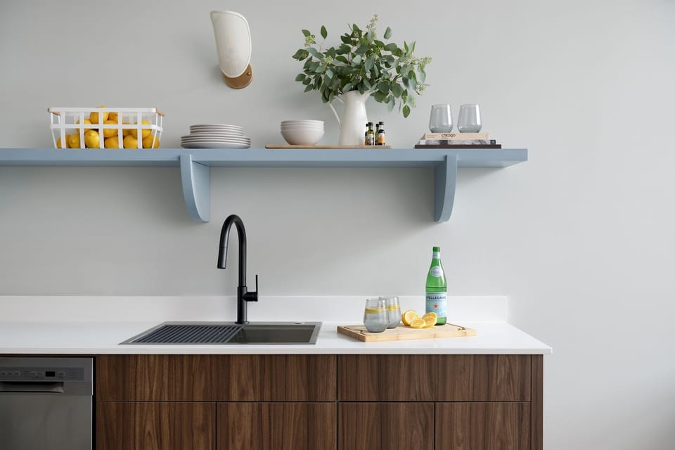 Sink, bowls, plates, wine glasses, coffee cups.