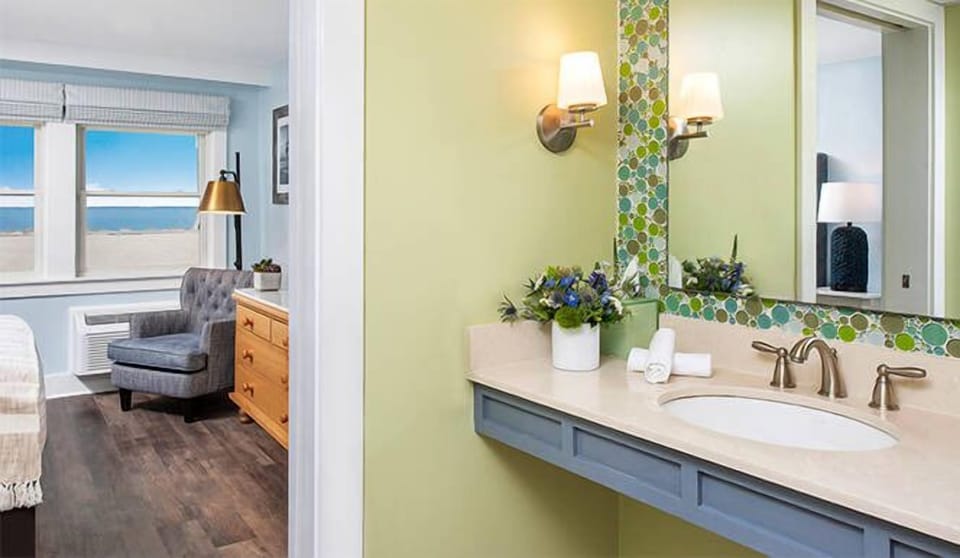 Refresh at the stylish vanity with bright lighting and plush towels.