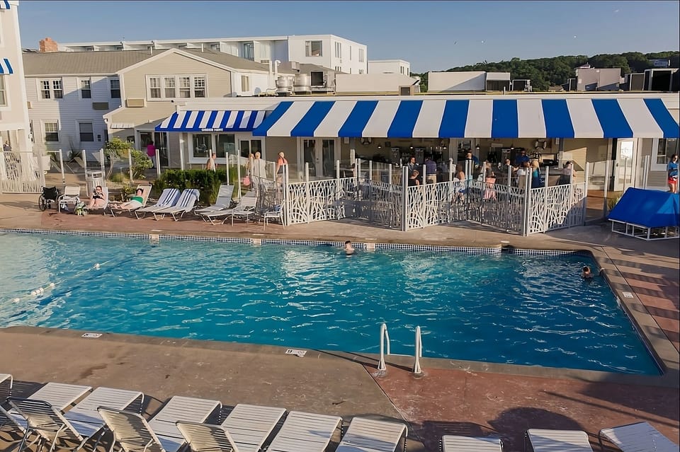 Cool off with lively pool energy beside the striped lounge.