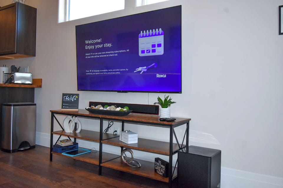 65" UHD Smart TV with guest check-in/check-out functionality.
