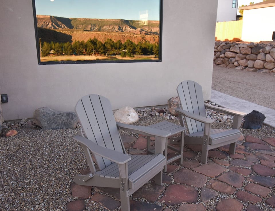 The front patio with reflection of Gooseberry Mesa in casita picture window.