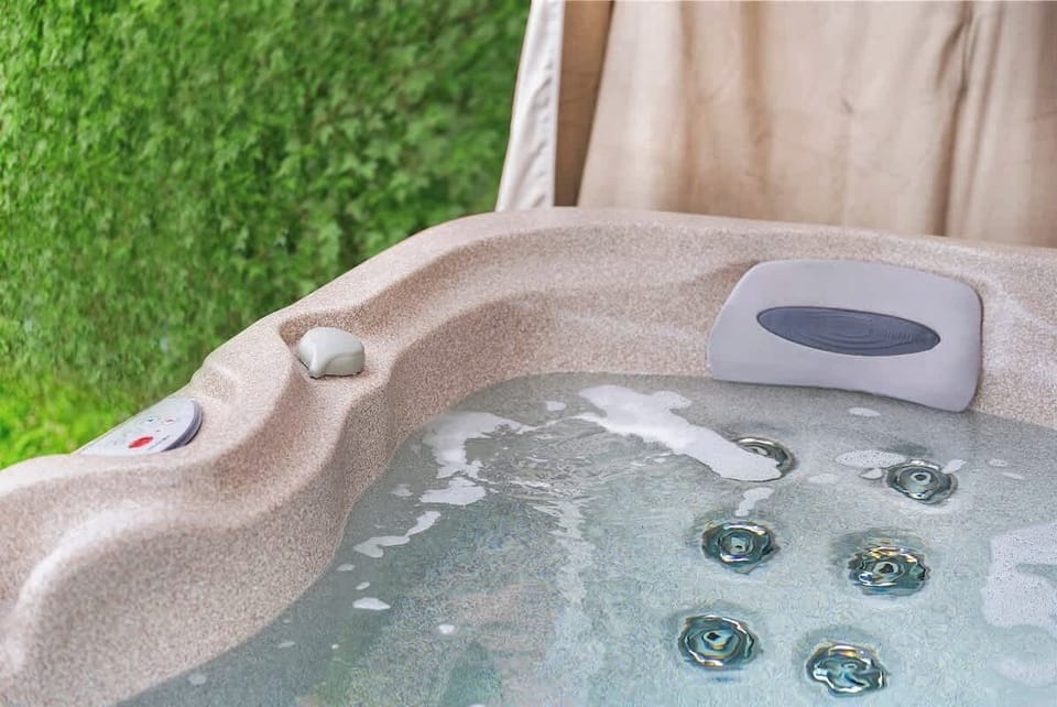 Bubbling hot tub beside privacy greenery for laid-back North Park nights and post-beach soaks in San Diego