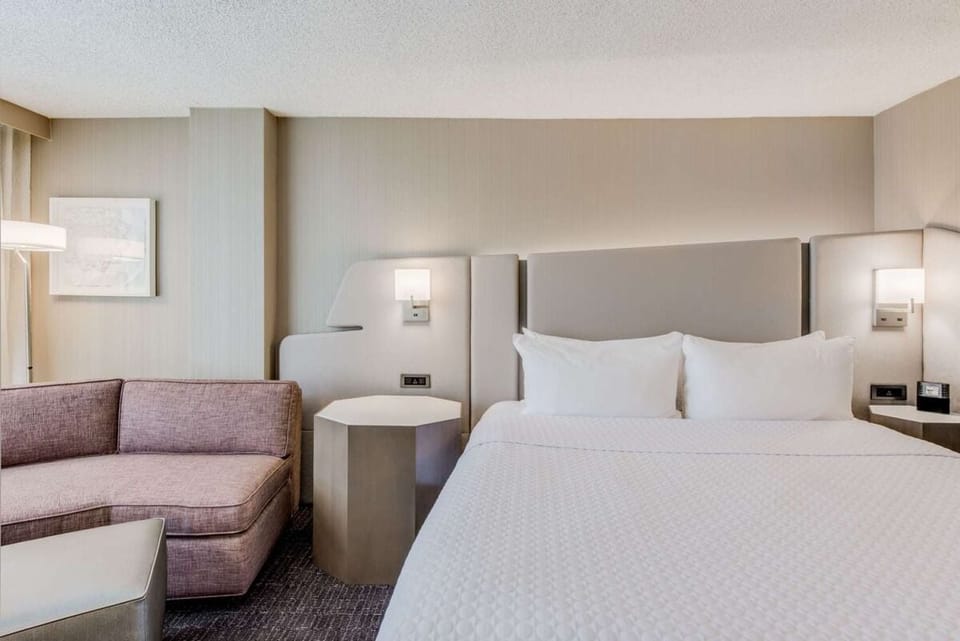 Sink into plush comfort beside sunlit windows and a work desk.