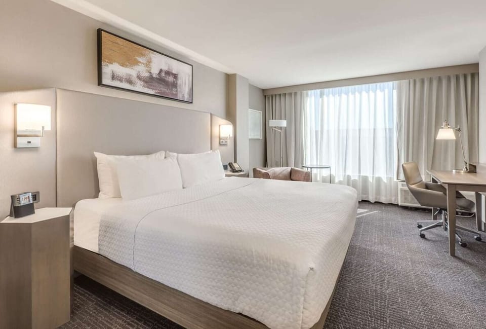 Drift off in crisp linens under warm bedside lighting.