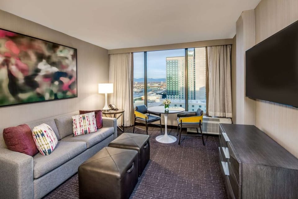 Unwind on the plush sofa with skyline views ahead.