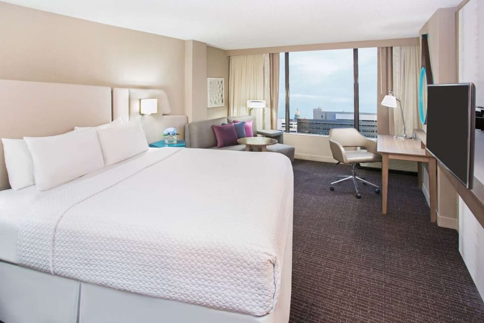 Sink into plush king linens while admiring sweeping city views.
