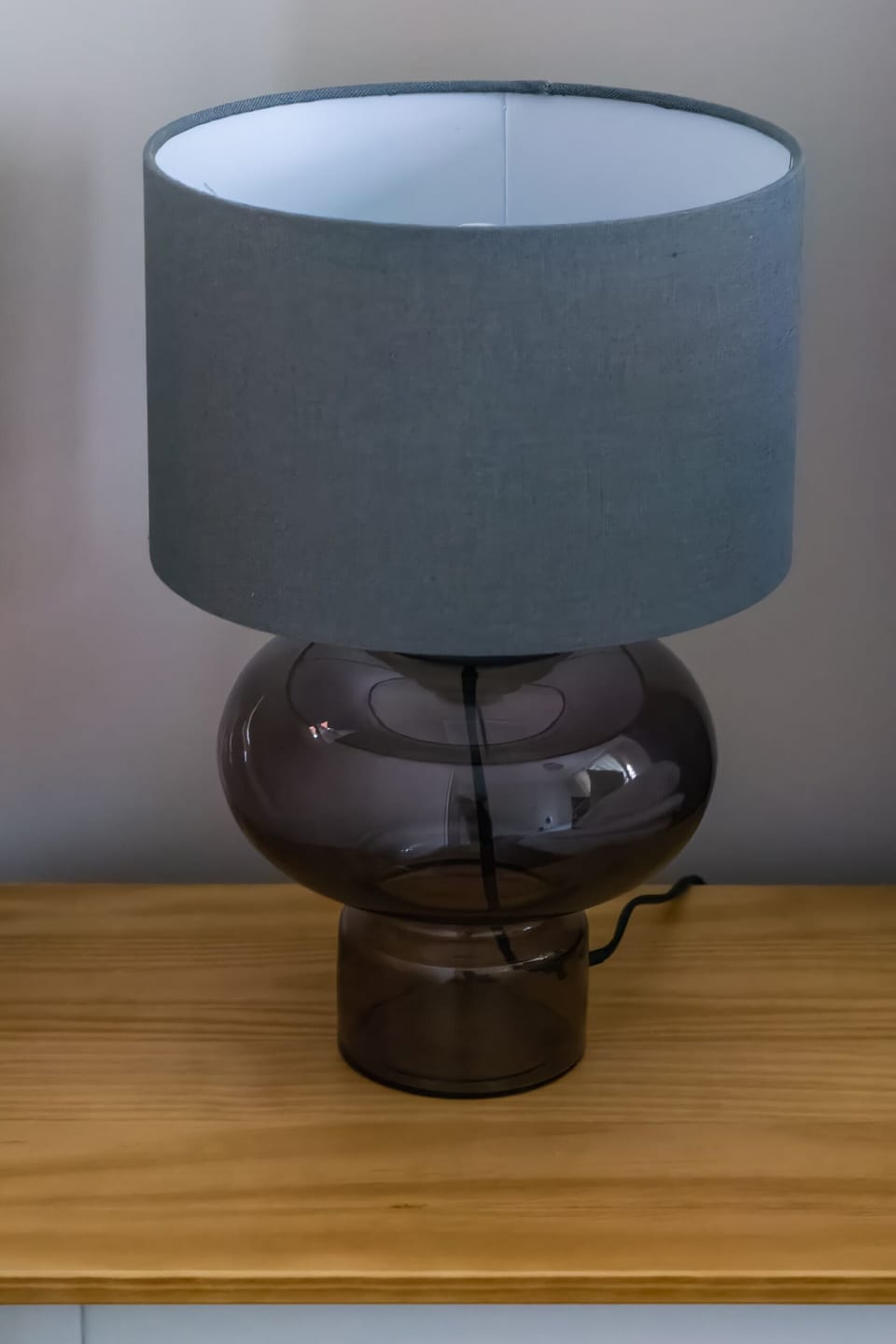 A bedside table with a stylish modern lamp, adding warmth to the space.


