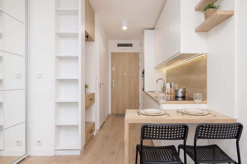A view of the open-plan layout showing the kitchen and dining area, blending function and style.


