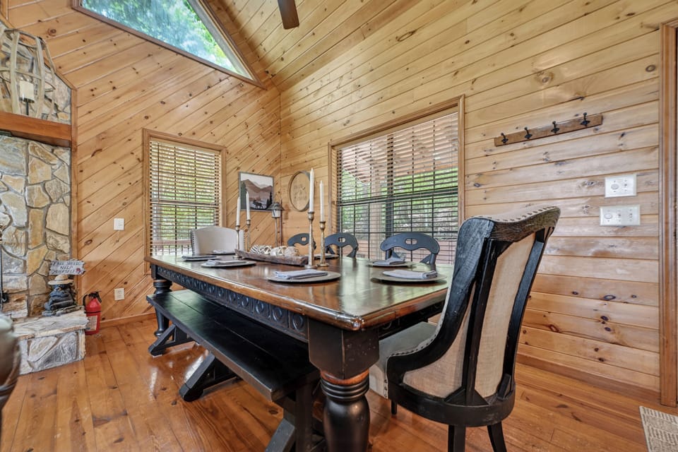 Enjoy meals together at the spacious dining table surrounded by warm wood interiors and cabin-style deco