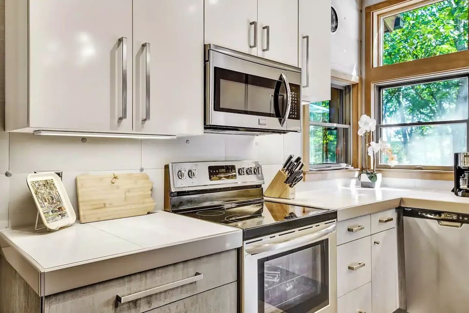 Bright and airy fully equipped kitchen with modern stainless steel appliances