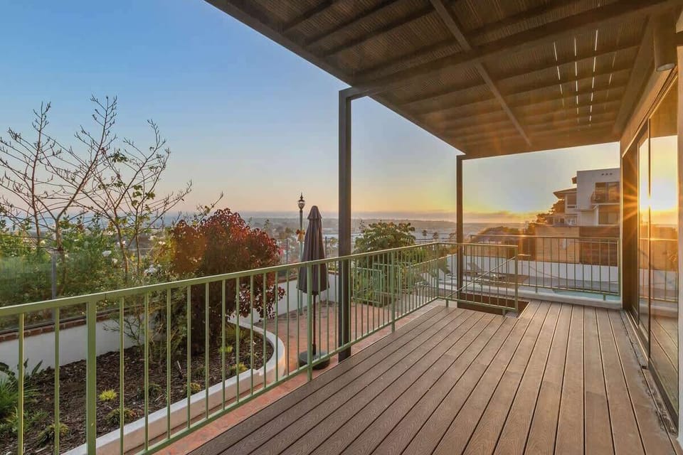 Large wrap-around deck connecting the lower floor living room, king studio suite, and pool with amazing views of the sunset.