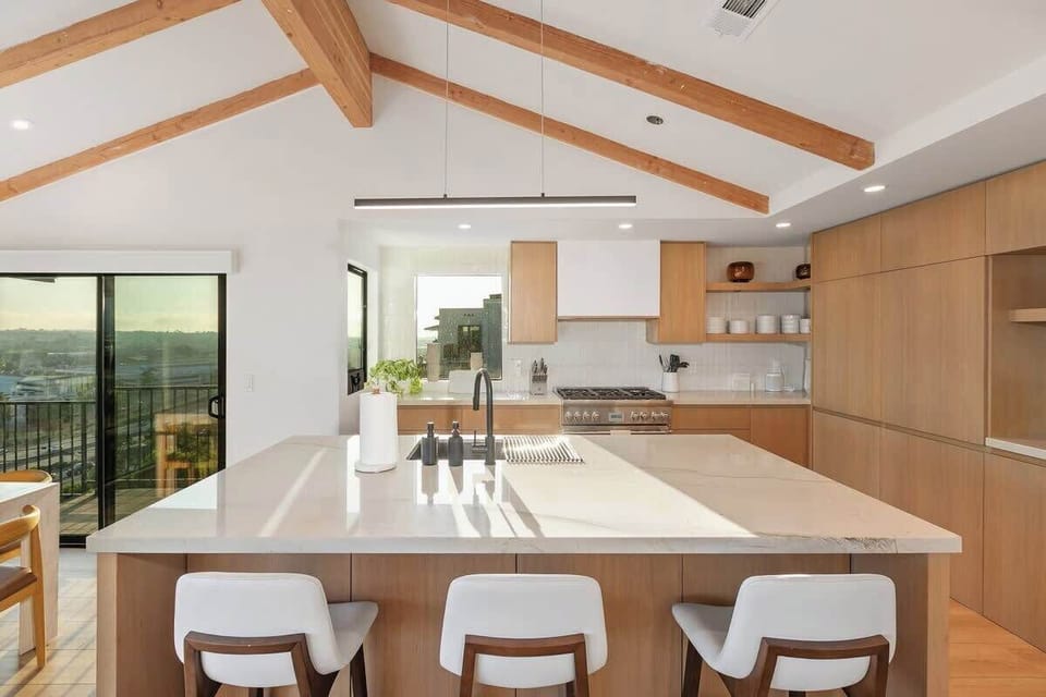 Fully stocked kitchen equipped with all the modern amenities, bar seating, and coffee bar.