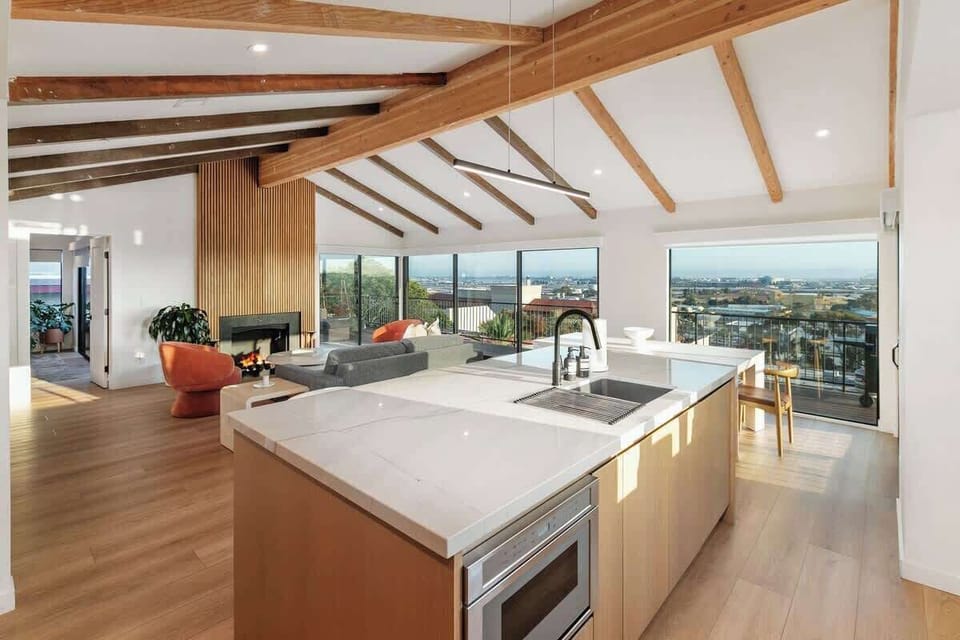 The great room, kitchen, and dining area with panoramic views of San Diego. 