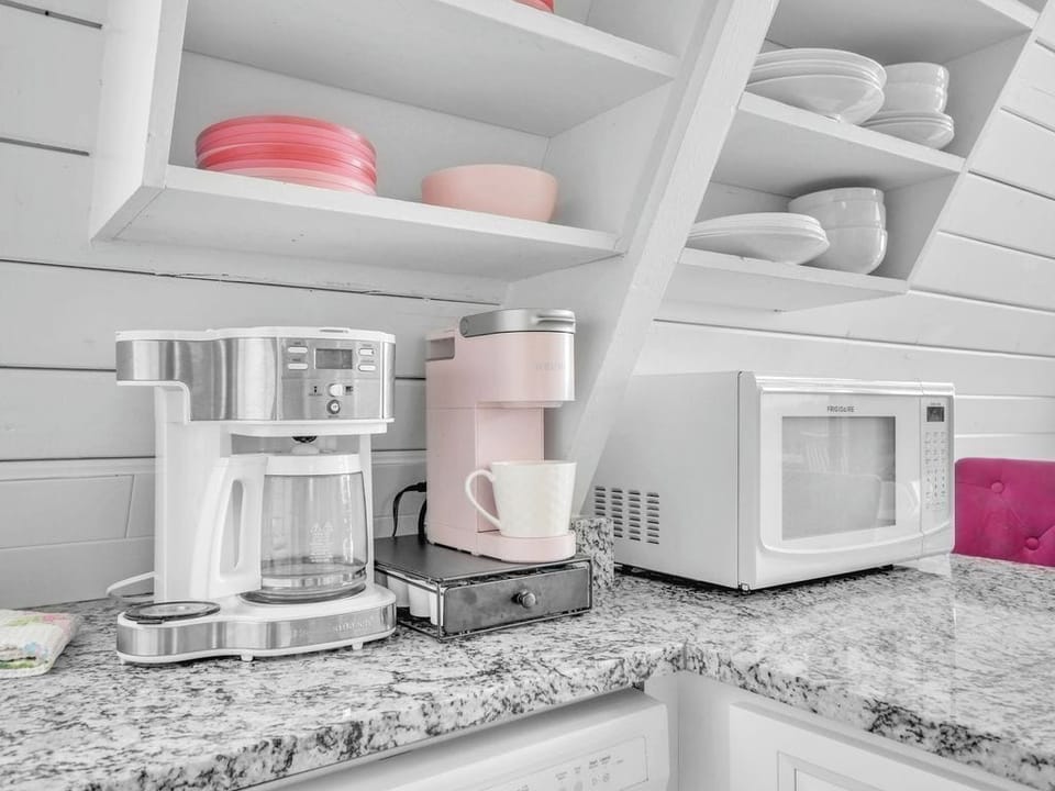 Kitchen with coffee pot and individual Keurig coffee maker. 