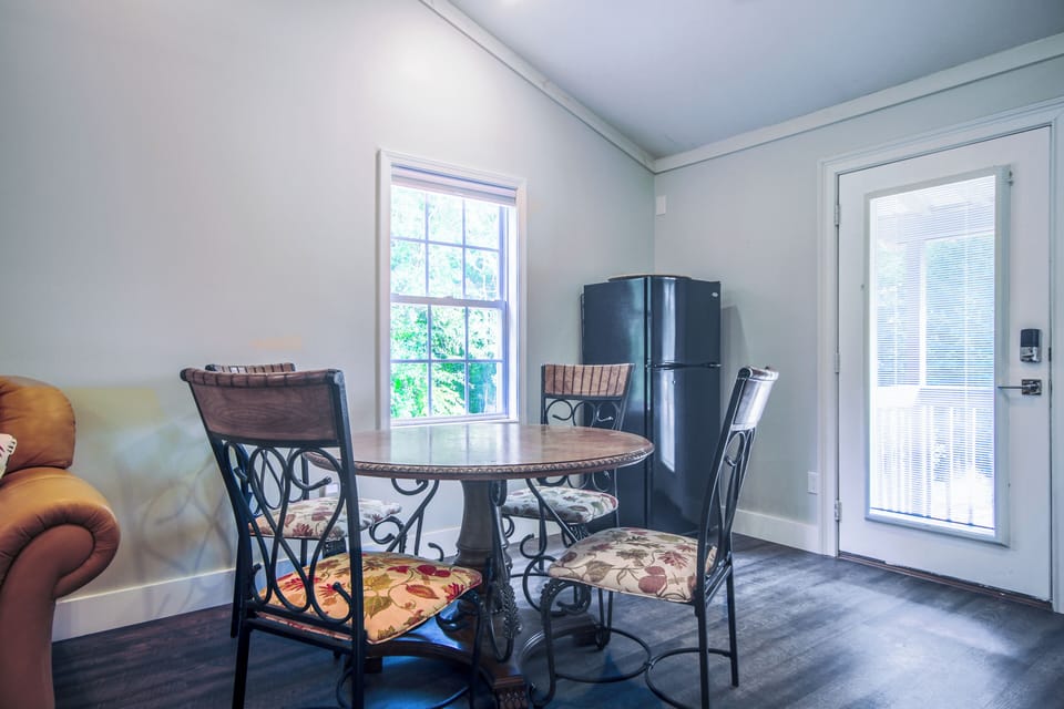 Dining area with medium size fridge. 