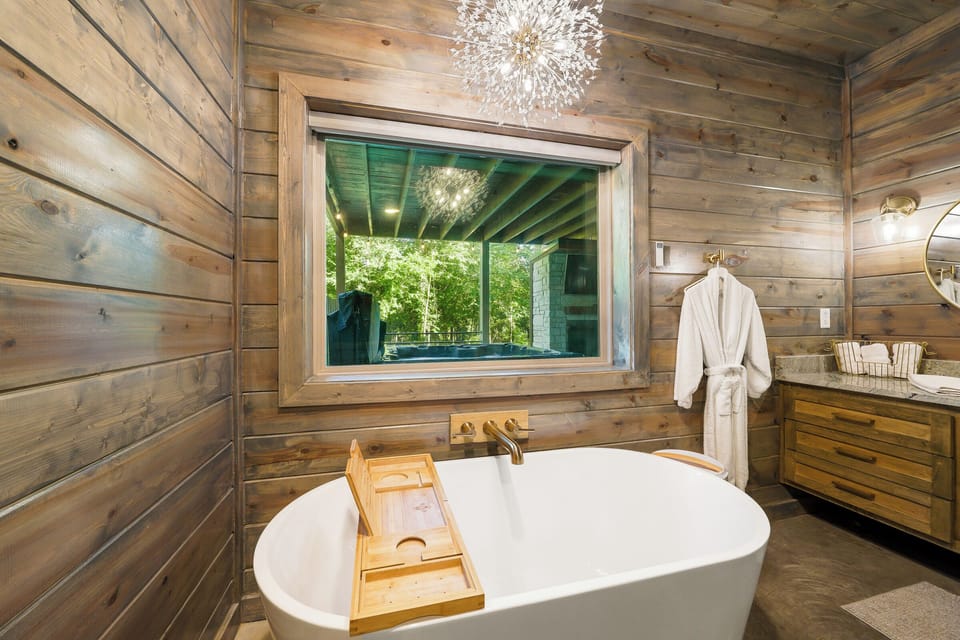 You’ll love the convenience of the gorgeous, “rustic glam” bathroom with double-sink vanity, soaking tub under a striking chandelier, and large walk-in shower.