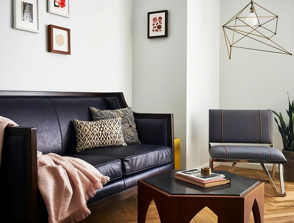 Unwind on the sleek sofa with warm, cozy vibes.