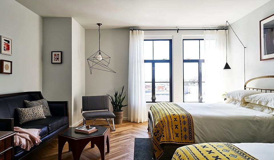 Unwind in a sunlit suite with cozy lounge seating.