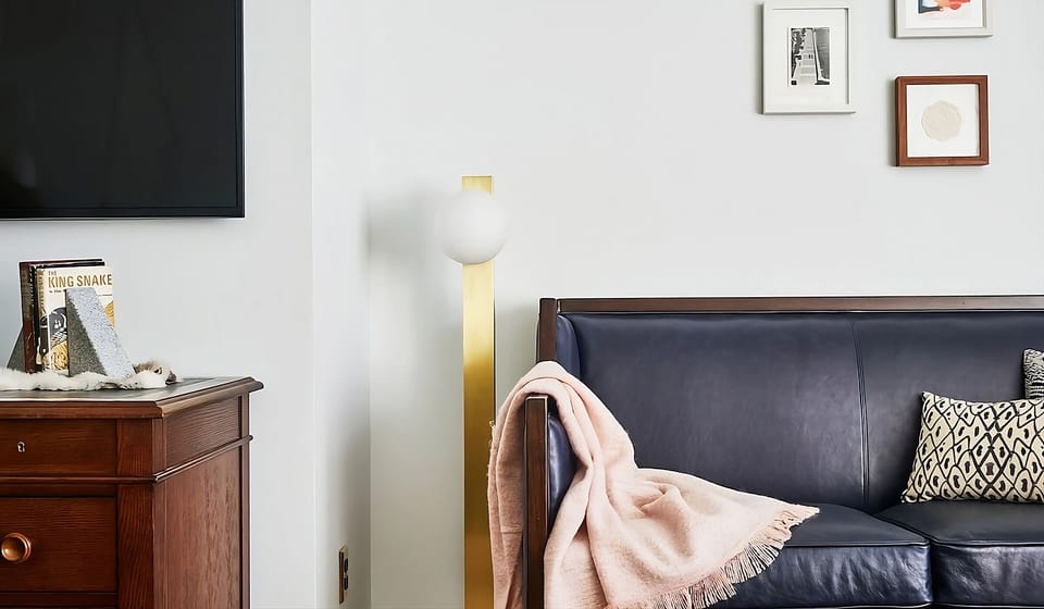 Sink into the leather sofa beside warm wood and art.