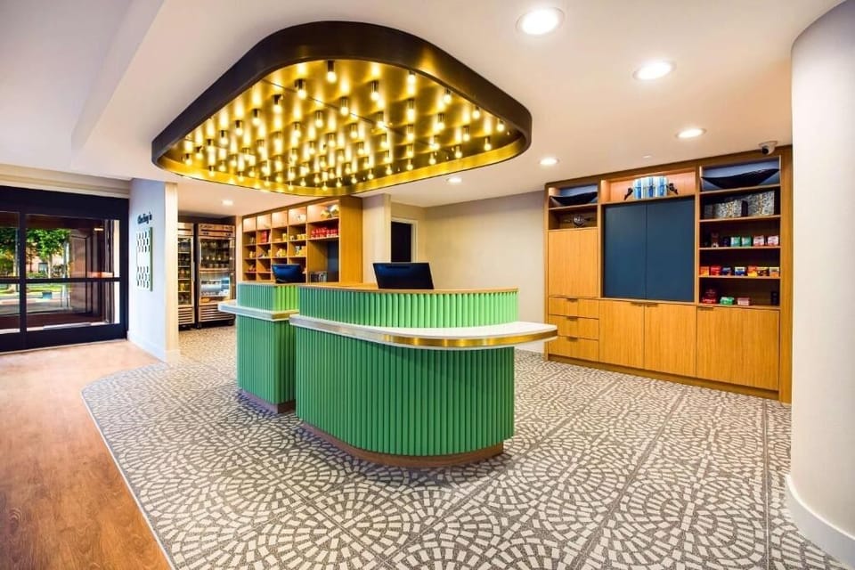 Check in smoothly beneath a glowing canopy and modern desk.