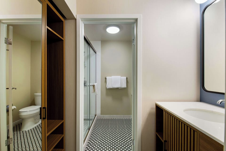 Refresh easily with a sleek vanity and spacious glass shower.