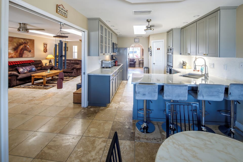 Fully Stocked Kitchen adjacent to Living Room with Smart TV and Internet.