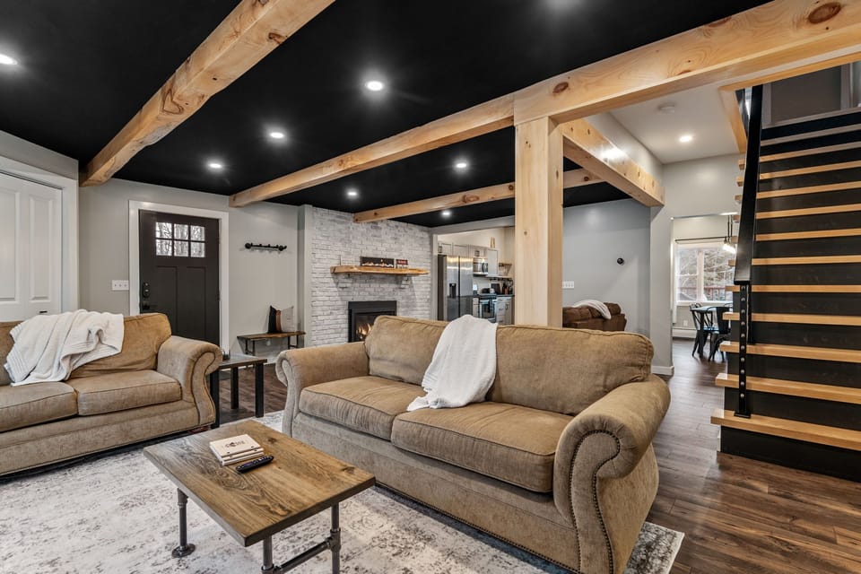 Large open living room with a gas fireplace, Smart TV, books and games! 