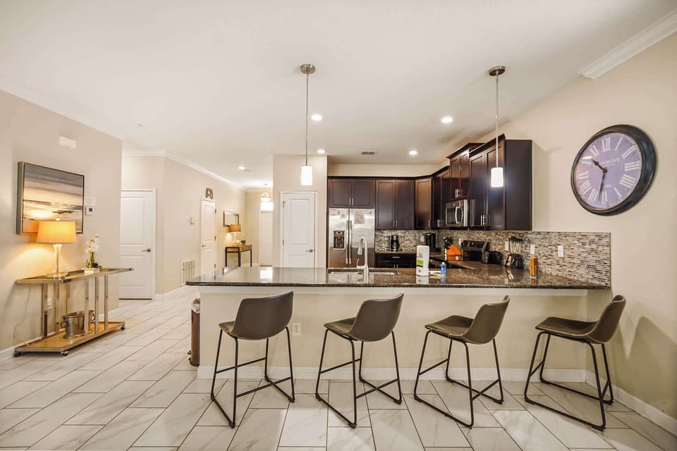 Spacious kitchen with elegant granite countertops and a breakfast bar, perfect for family gatherings and culinary adventures.