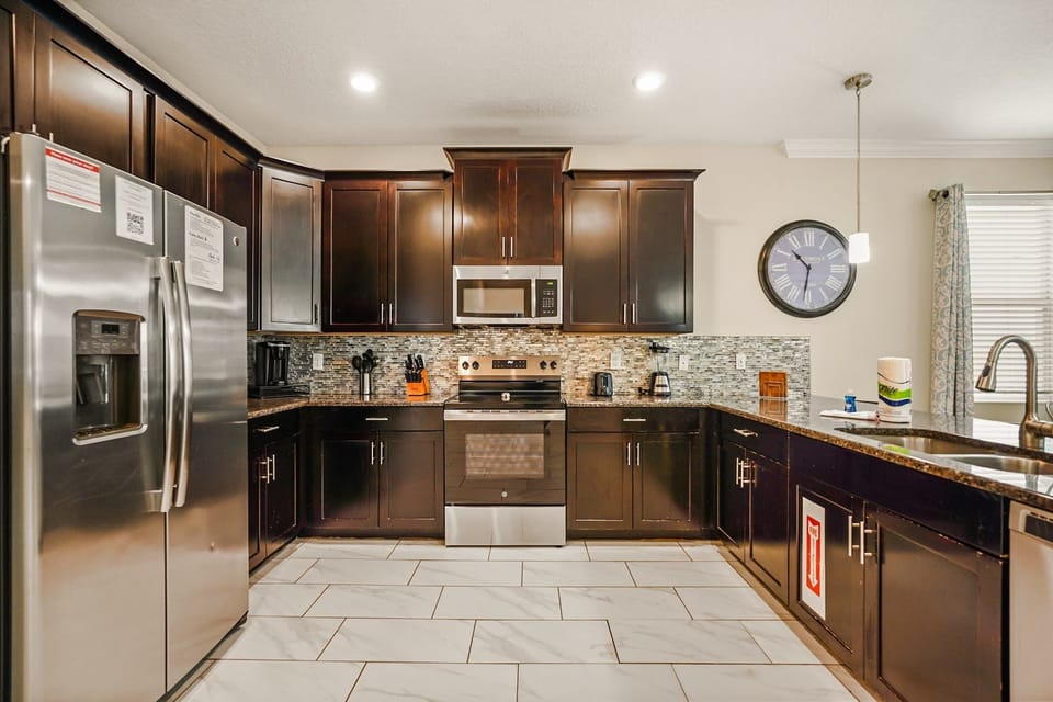Sleek kitchen with modern appliances and ample counter space, ideal for culinary adventures in a spacious villa.