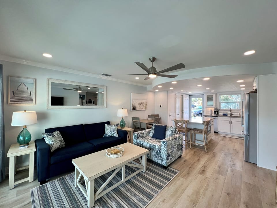 Your bright, coastal-inspired living space flows seamlessly into the kitchen, perfect for gathering with loved ones.